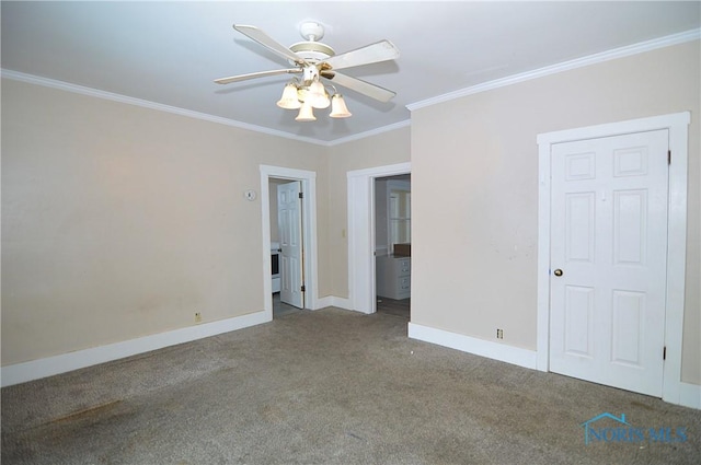 spare room with carpet floors, crown molding, and ceiling fan