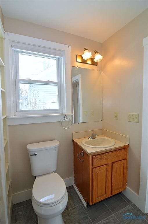 bathroom featuring toilet and vanity