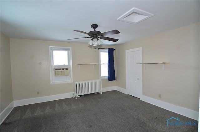 empty room with ceiling fan, dark colored carpet, cooling unit, and radiator heating unit