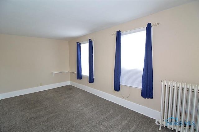 carpeted empty room with radiator heating unit