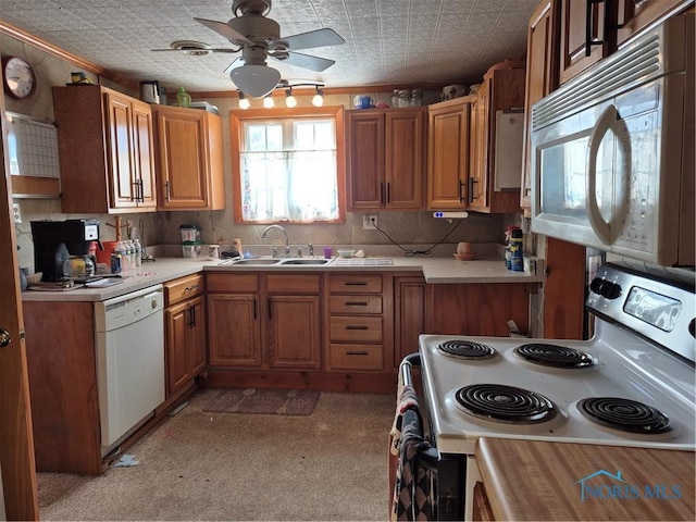 kitchen with ceiling fan, sink, and white appliances