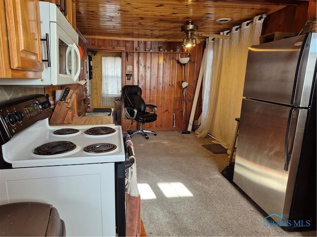 kitchen with ceiling fan, wood walls, white appliances, light carpet, and wood ceiling