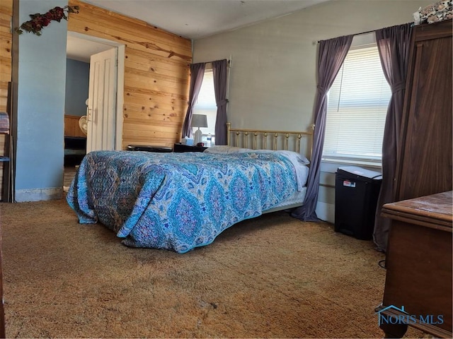 carpeted bedroom with wooden walls