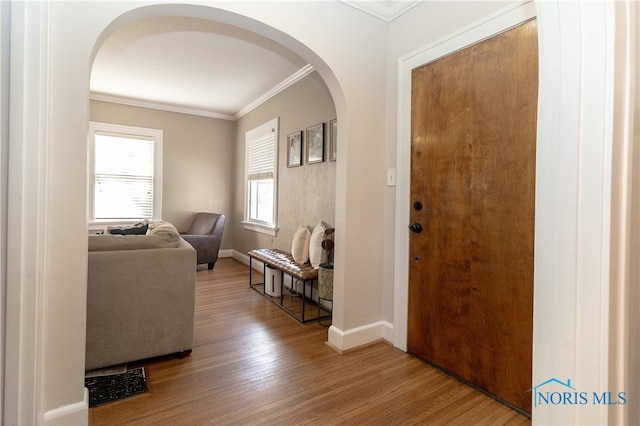 entrance foyer featuring hardwood / wood-style floors and ornamental molding