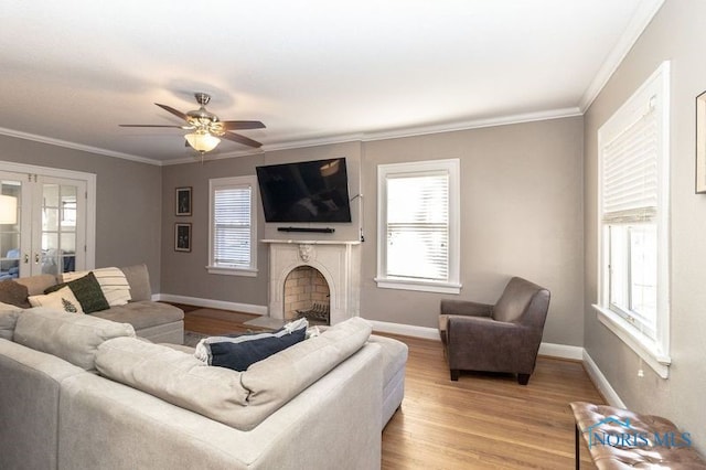 living room featuring wood-type flooring, french doors, ceiling fan, and crown molding