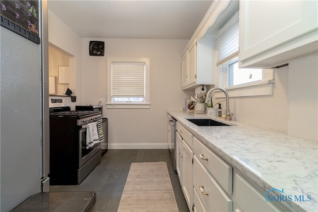 kitchen with sink, white cabinets, and stainless steel appliances