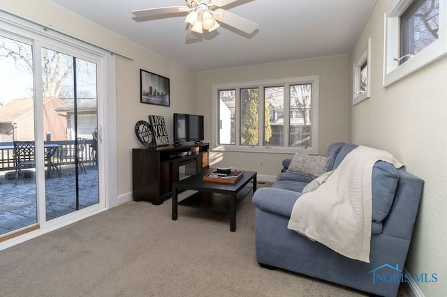 sitting room featuring ceiling fan, a healthy amount of sunlight, and light colored carpet