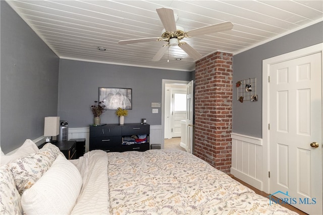 bedroom with ceiling fan and ornamental molding