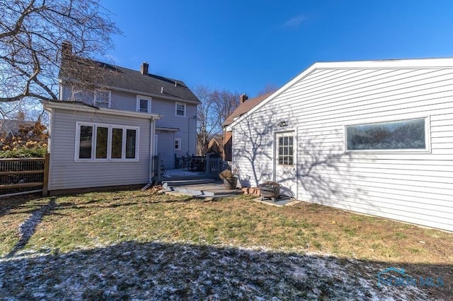 back of house with a lawn