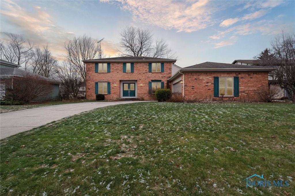 view of front of house with a yard and a garage