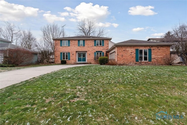 view of front of home with a front yard and a garage