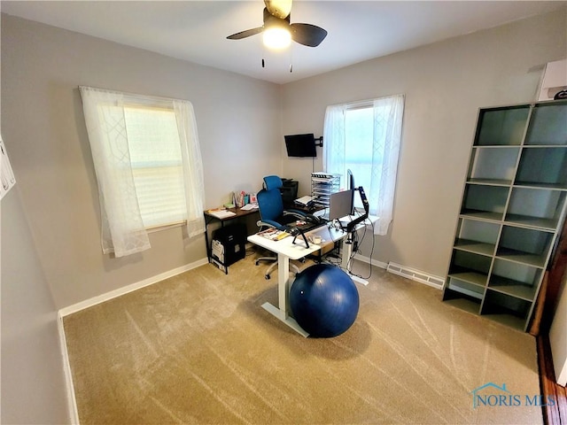 carpeted office featuring ceiling fan