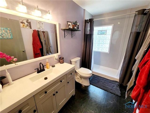 bathroom featuring a shower with curtain, toilet, and vanity