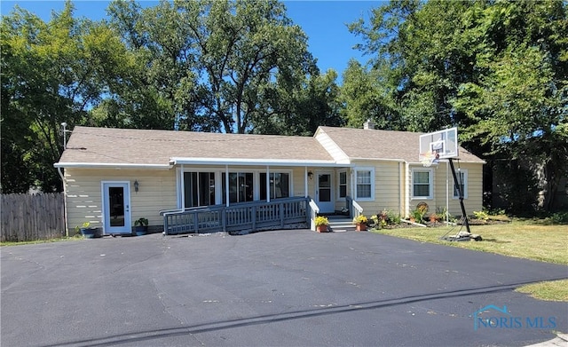 ranch-style house with covered porch and a front yard