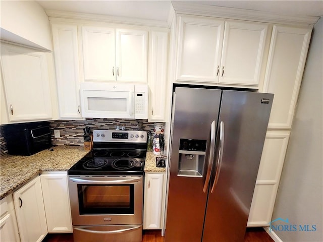 kitchen featuring white cabinets, light stone countertops, stainless steel appliances, and tasteful backsplash