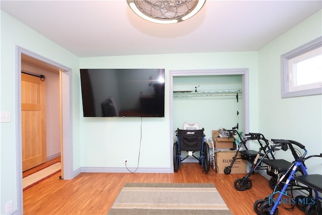 exercise area with light hardwood / wood-style floors