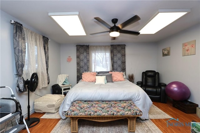 bedroom with ceiling fan and hardwood / wood-style floors