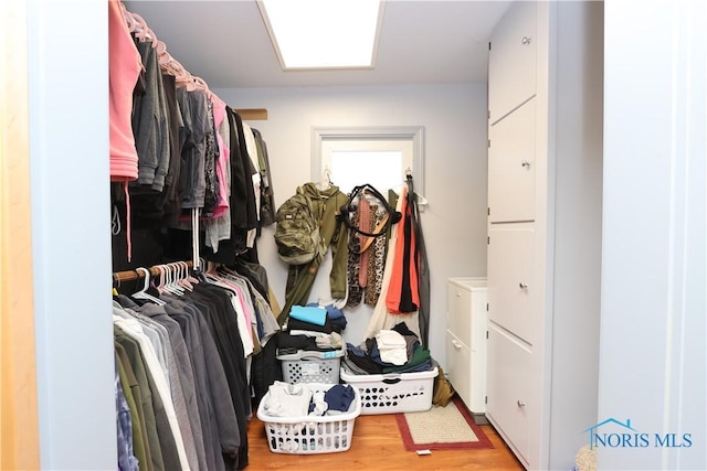 spacious closet featuring light hardwood / wood-style flooring