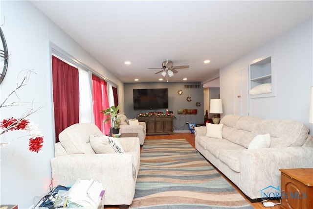 living room featuring ceiling fan and hardwood / wood-style floors