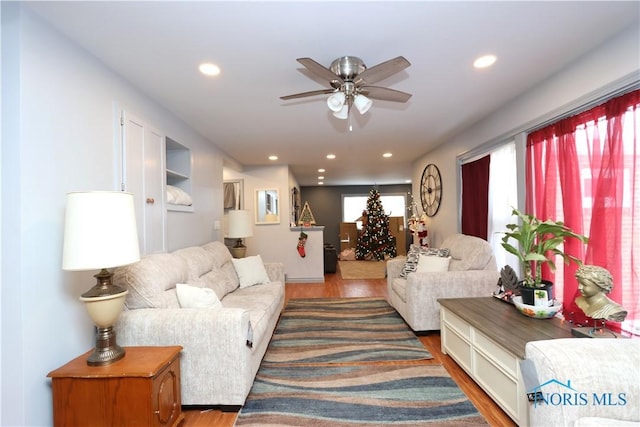 living room featuring ceiling fan and hardwood / wood-style floors