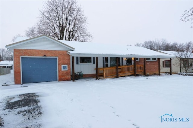 ranch-style home with covered porch and a garage