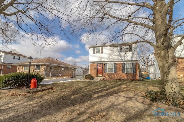 back of property featuring a yard