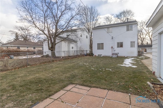 back of house with a patio and a lawn