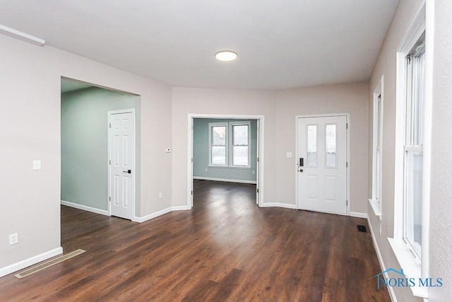 foyer entrance with dark hardwood / wood-style floors