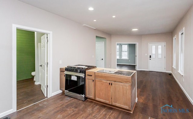 kitchen with dark wood-type flooring, black electric cooktop, and stainless steel range with gas stovetop