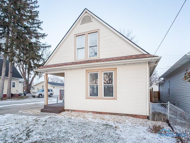 view of snow covered rear of property