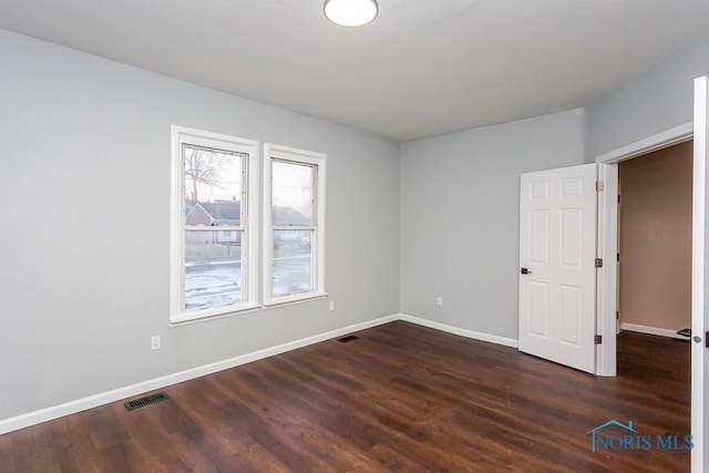 empty room with dark hardwood / wood-style floors