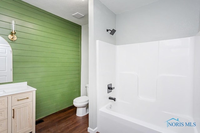 full bathroom with vanity, bathing tub / shower combination, and toilet