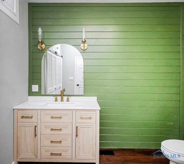 bathroom featuring vanity and toilet