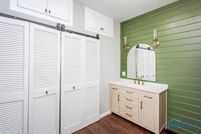 bathroom with vanity and wooden walls