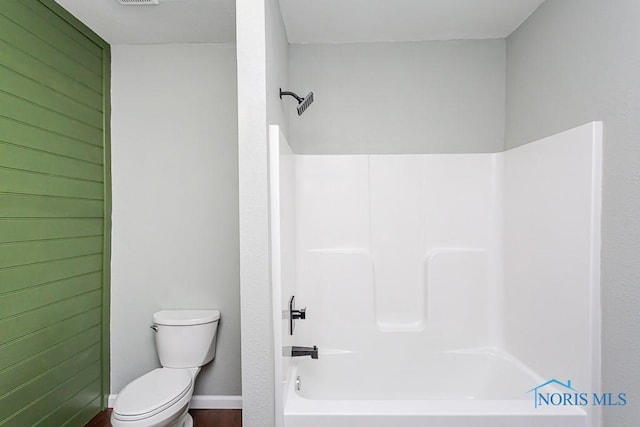 bathroom featuring toilet and shower / bath combination