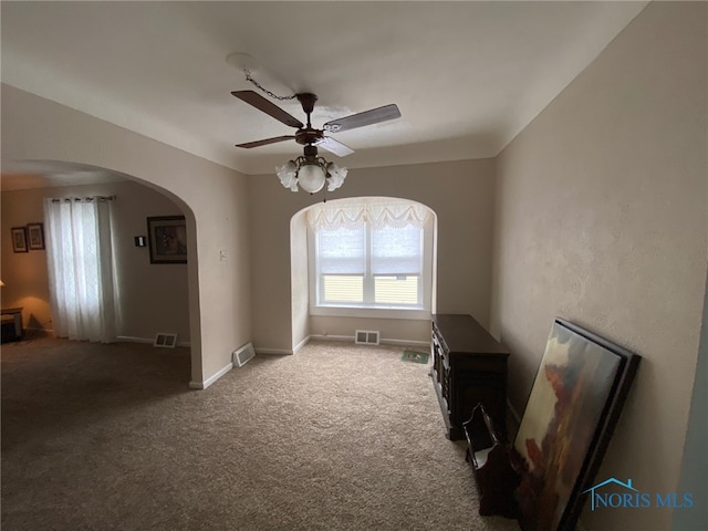 carpeted living room with ceiling fan