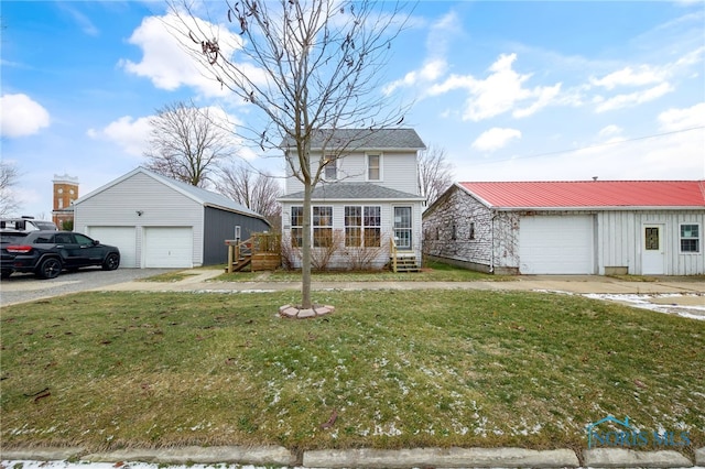 front of property featuring a front lawn, an outdoor structure, and a garage