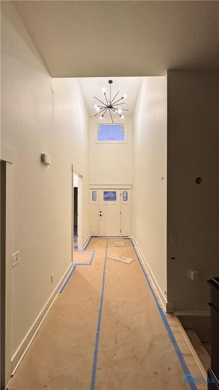 interior space with a towering ceiling and a chandelier