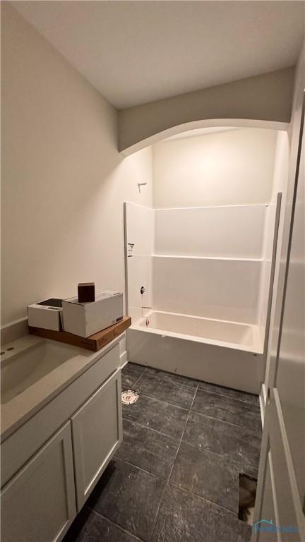 bathroom featuring vanity and  shower combination