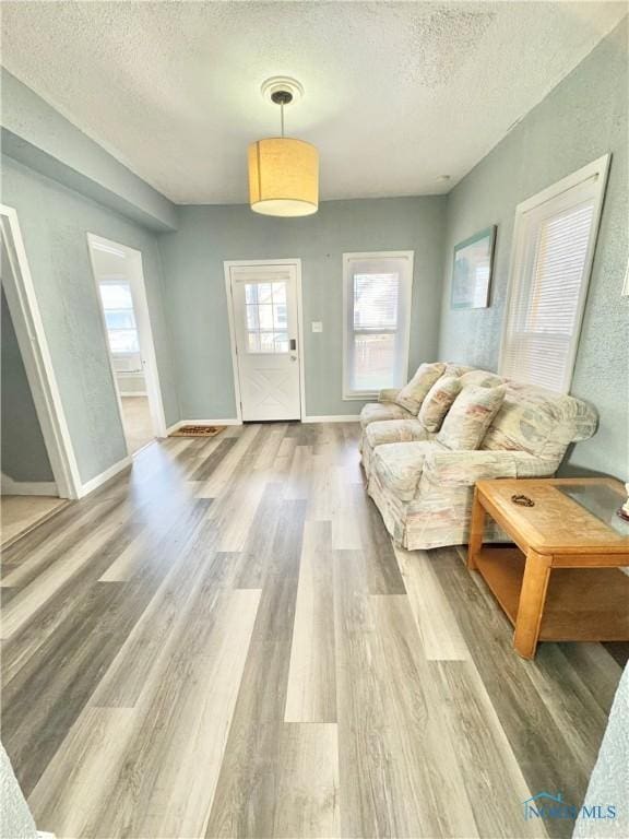 living room featuring a textured ceiling and hardwood / wood-style flooring