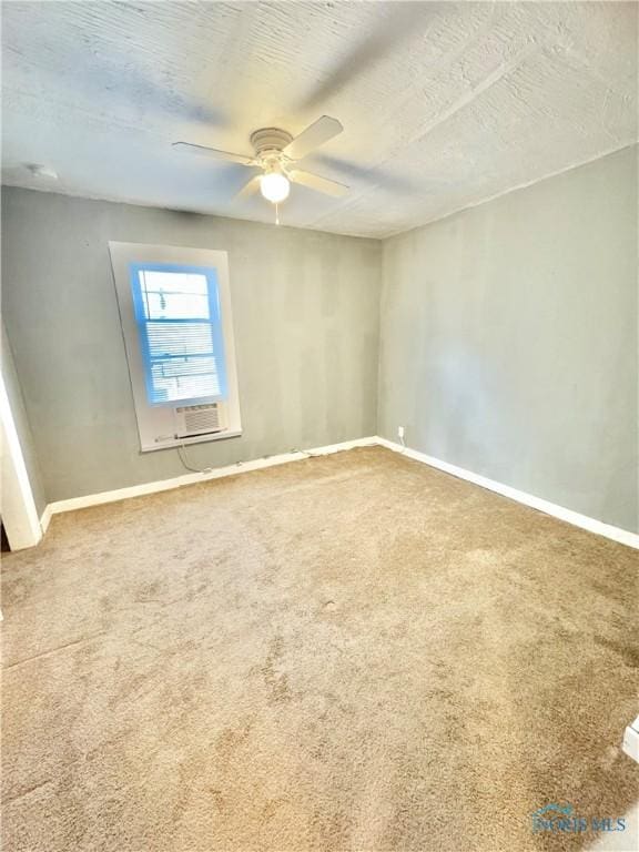 spare room featuring carpet flooring, ceiling fan, cooling unit, and a textured ceiling