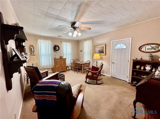 carpeted living room with ceiling fan