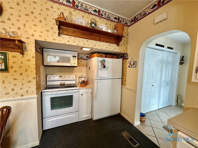 kitchen featuring light tile patterned floors and white appliances