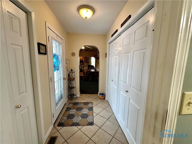 doorway to outside featuring light tile patterned floors