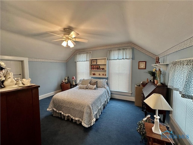 bedroom with ceiling fan, lofted ceiling, and dark colored carpet