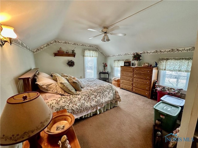 carpeted bedroom with ceiling fan and lofted ceiling