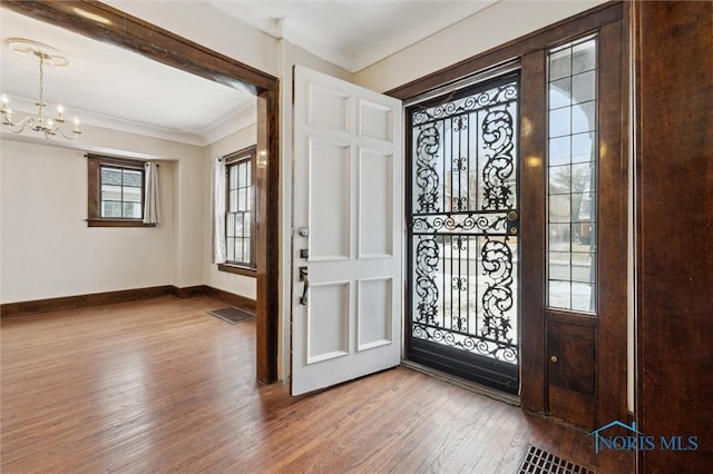 entryway with a chandelier and wood-type flooring