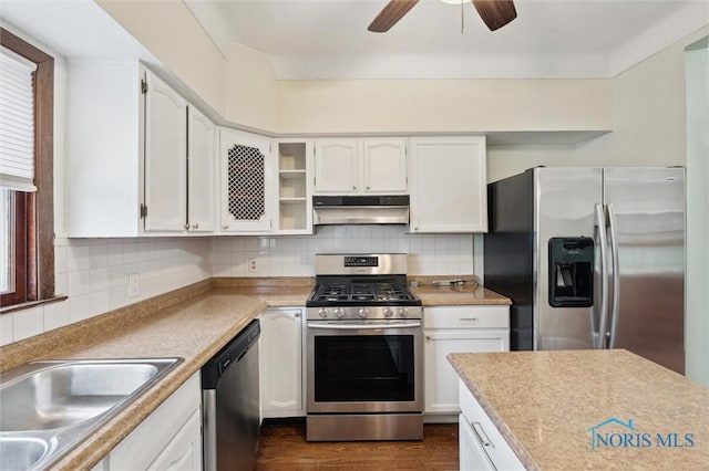 kitchen featuring ceiling fan, stainless steel appliances, white cabinets, and tasteful backsplash