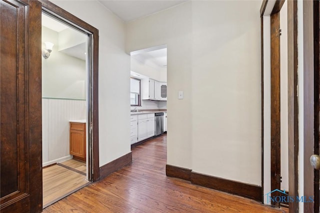 hall with dark hardwood / wood-style flooring and sink