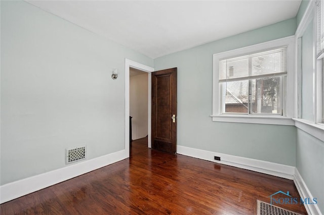 unfurnished room featuring dark hardwood / wood-style flooring